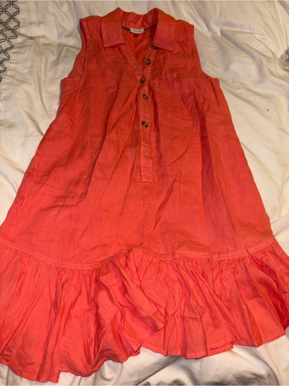 Pilcro by Anthropologie Sleeveless V-Neck Linen Flounce Mini Dress in coral.